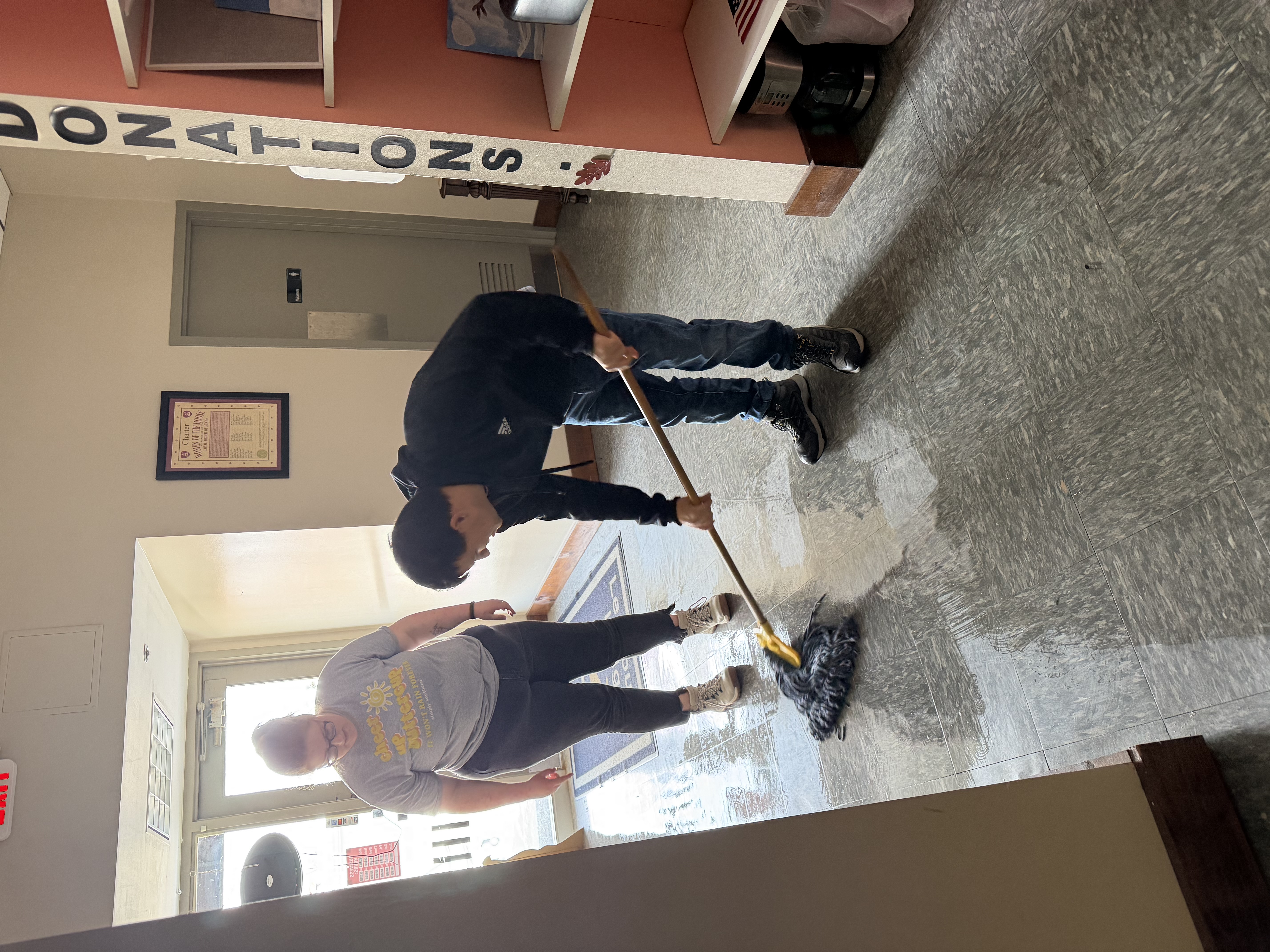 Participants practicing sweeping and cleaning
