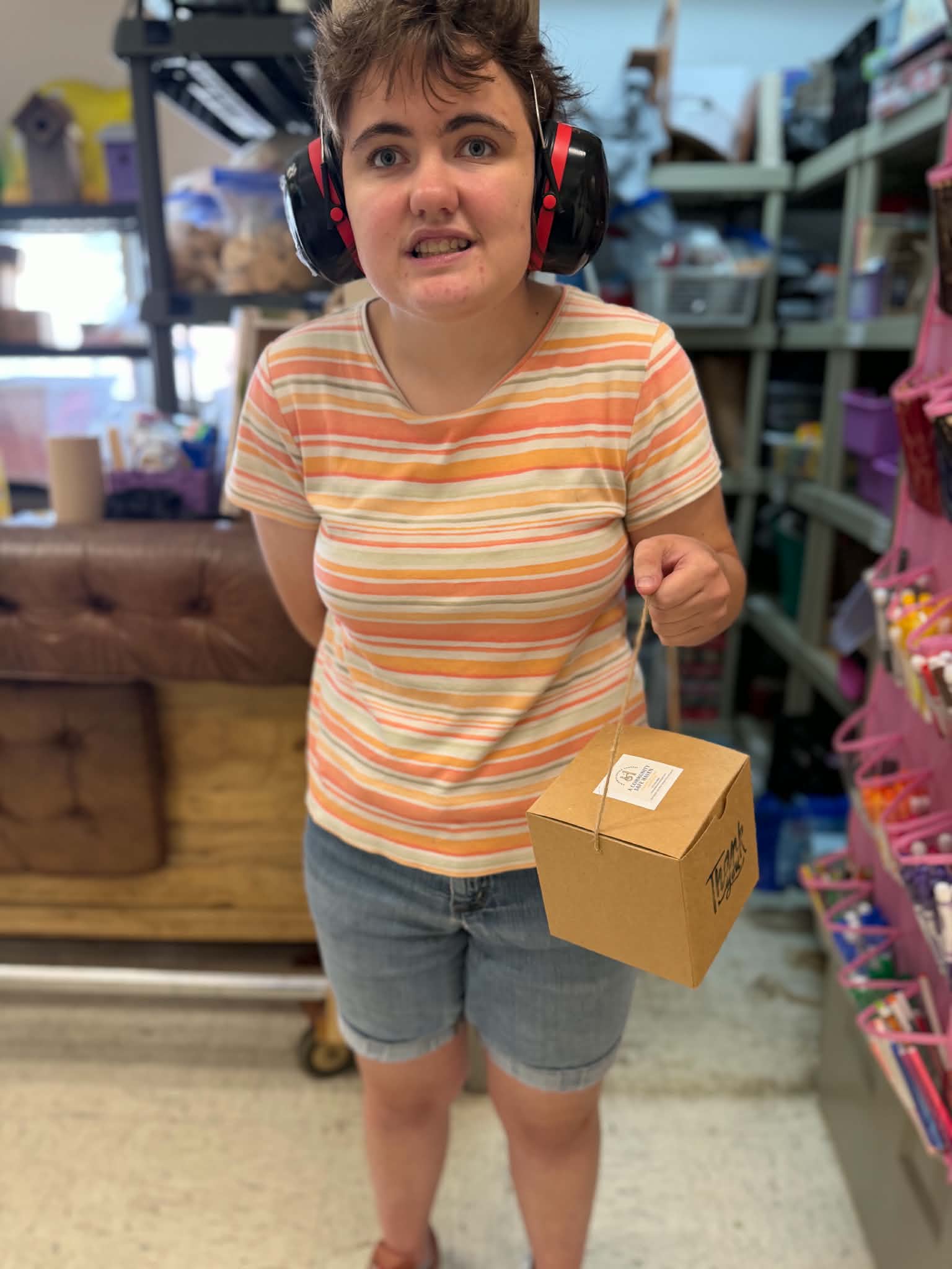 A Community Safe Haven participant holding a handmade gift box